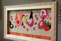 A colorful folk-art style textile or fabric print featuring stylized roosters and chickens with floral patterns on a cream background, bordered by green and orange decorative bands.
