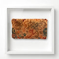 A rectangular fabric pouch.  featuring a vintage floral stencil pattern in shades of brown, orange, and teal on a tan bag