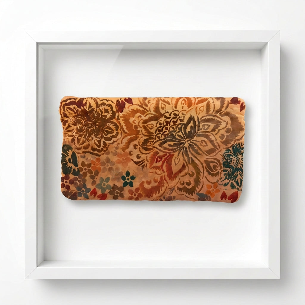 A rectangular fabric pouch.  featuring a vintage floral stencil pattern in shades of brown, orange, and teal on a tan bag