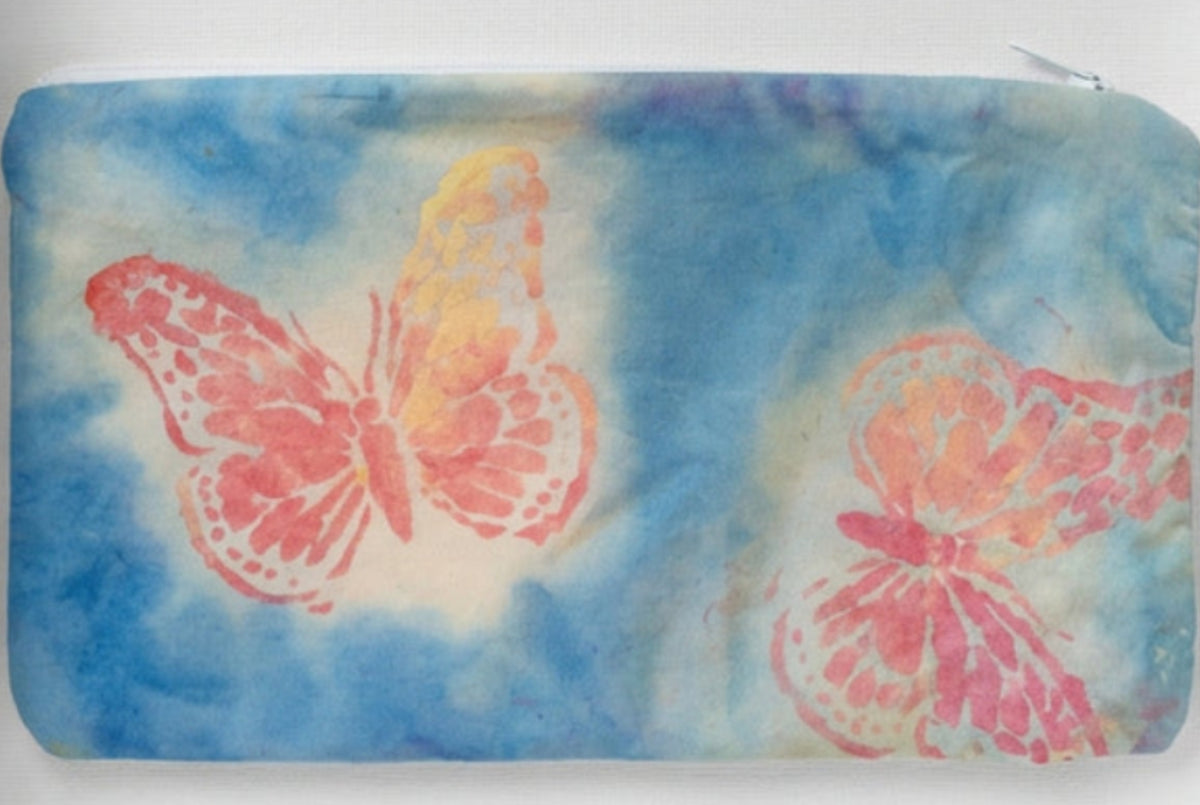 A rectangular fabric pouch or sleeve with a blue-gray background and two large butterfly prints in pink, orange, and yellow.