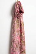 A pink patterned fabric or scarf with a metallic gold damask design.