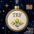A needlepoint canvas from Yellow City Fibers featuring the initials 'TRF' in brown with yellow flowers and a green stem in the center, displayed on a white surface.