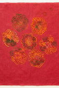 A square piece of red fabric with six embroidered floral motifs in gold, orange, and blue.